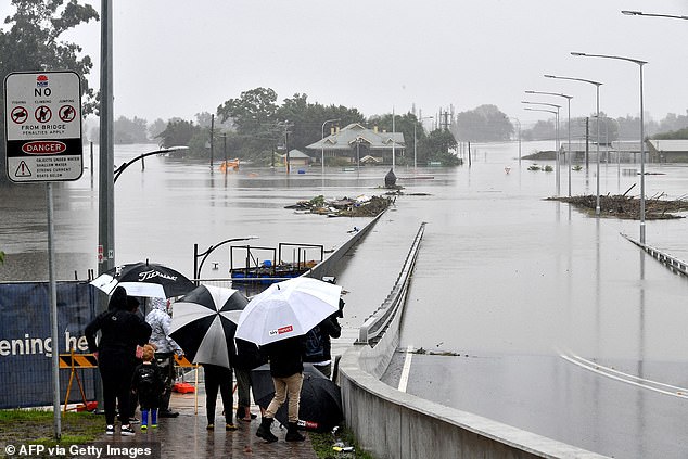 One dead, thousands urged to evacuate as Australia's northeast battles floods